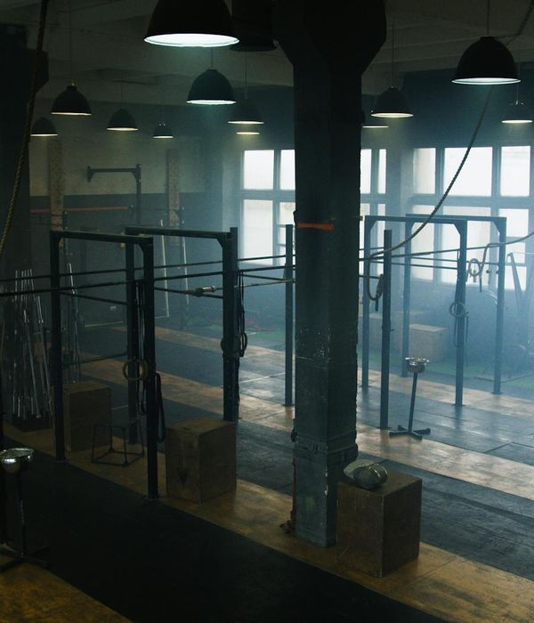 Man performing a functional strength exercise in a bright space.